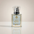 Perfume bottle labeled 'Blue Magnet' on a reflective surface with a neutral background
