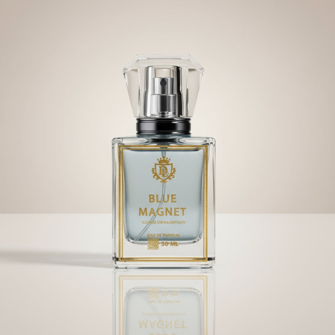 Perfume bottle labeled 'Blue Magnet' on a reflective surface with a neutral background